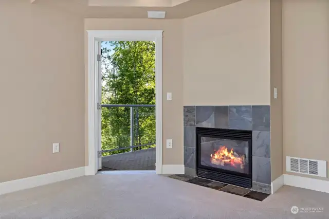 The living room has a natural gas fireplace insert with the slate surround. There is access to a deck that also opens to the primary bedroom.