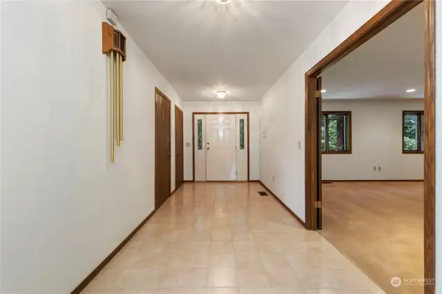 Front door entry and wide tiled hallway, french doors to the right lead to a giant family/great room.