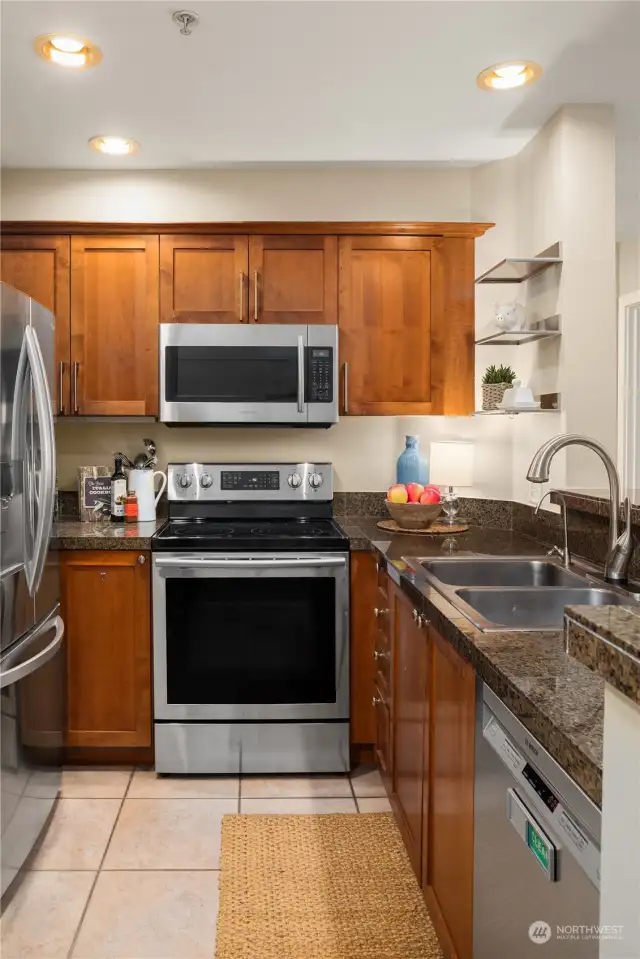 A stylish, functional kitchen with built-in water filter, automatic faucet, and stainless appliances (all included).