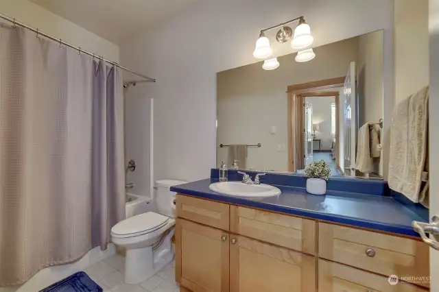 The main guest bath is complete with tub and shower and large vanity with great storage.
