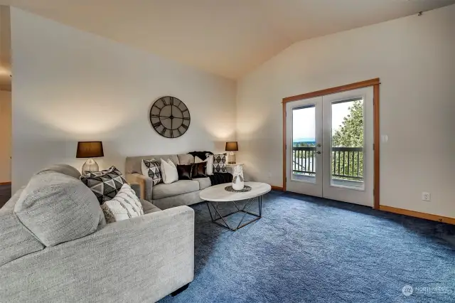Dramatic French doors lead to the covered balcony and one of your favorite spots to enjoy views of Poulsbo and the Olympic Mountains. Stay tuned for more view pictures to come.