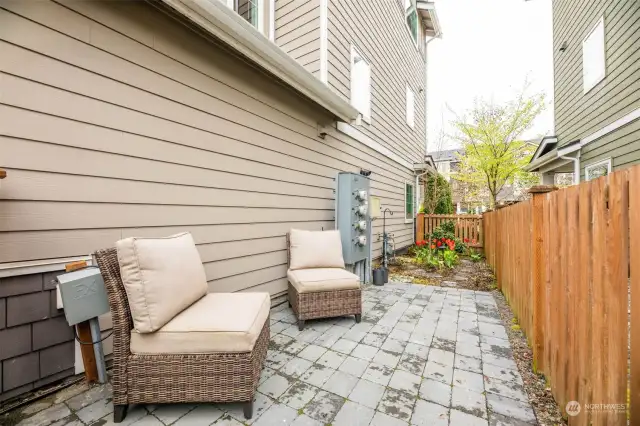 Fully fenced side yard with pavers and gardening space