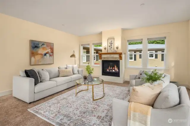 The spacious living room boasts a cozy gas fireplace, ideal for both relaxation and hosting guests.
