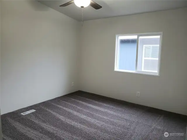 Nice Size Second Bedroom Showing Cathedral Ceiling, All New Paint, Carpet and Ceiling Fan.