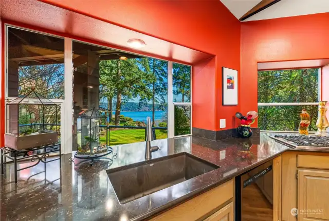 No more complaints about having to do the dishes here!  What a beautiful setting.  Yes, those are slab granite counters you see. There are also quartz counters.  Appliances were all replaced about 5 years ago.