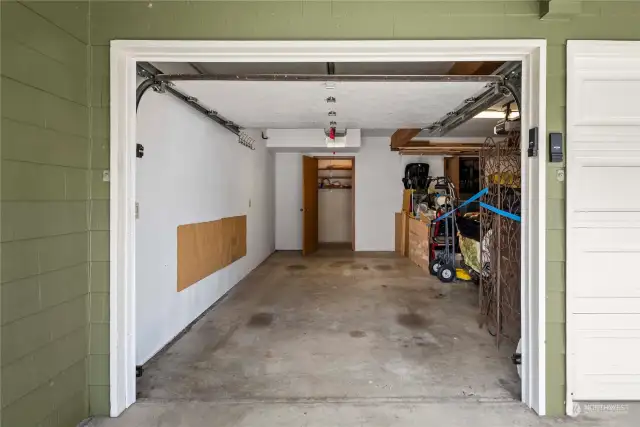 Garage space with storage room beyond.