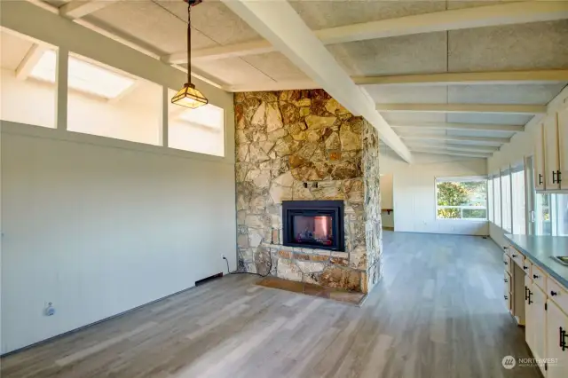 Floor to ceiling stone wall with gas fireplace.