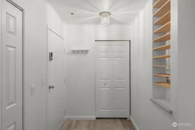 The entryway holds the deep walk-in storage closet and the laundry.