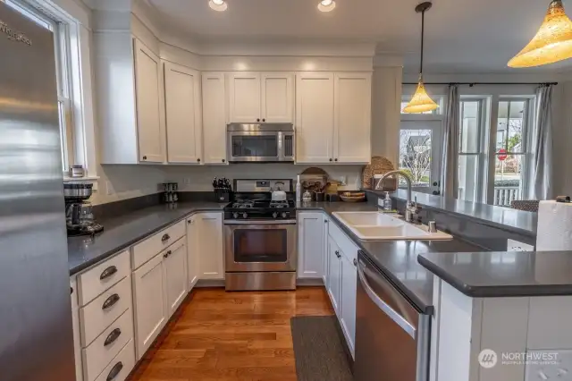 We love the warm wood floors that offset the painted cabinets and granite counters.