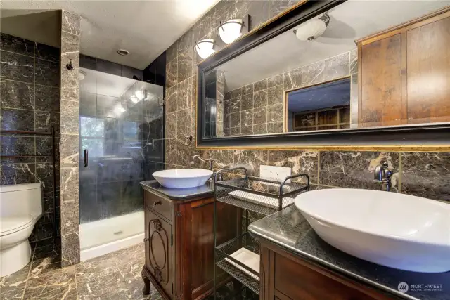 Designer sinks and lighting in the private primary bathroom.