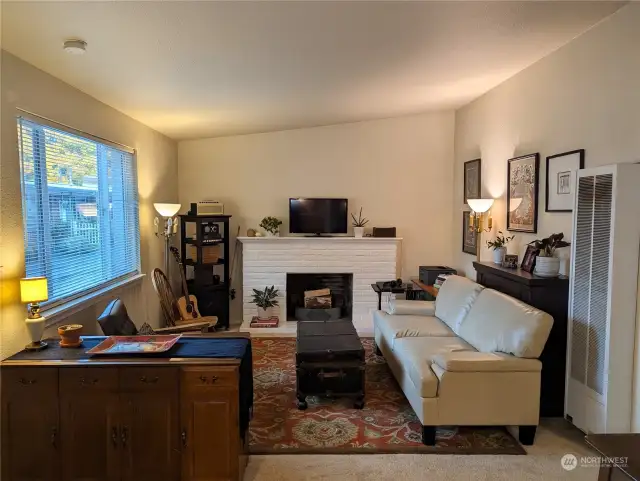 Living room with wood fireplace. 8414 John Dower Rd SW #3, Lakewood, WA 98499