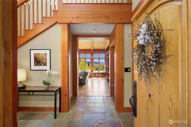 Natural light fills the two story atrium and entry, leading to tempting views of the water and mountain beyond.