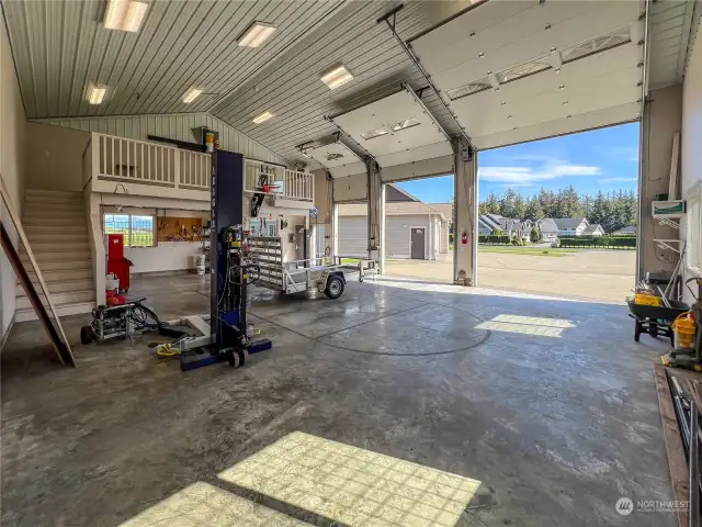 A shot into the 1418 Sq Ft 2X6 constructed shop with the doors up. The shop is complete with a hoist and air compressor and loft area. The shop is heated and is sure to be a favorite to all.
