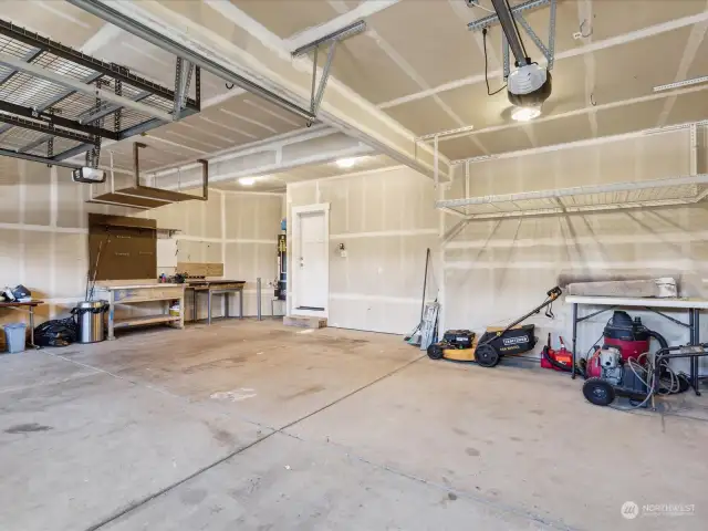 Huge 3-car garage with work bench and upper storage