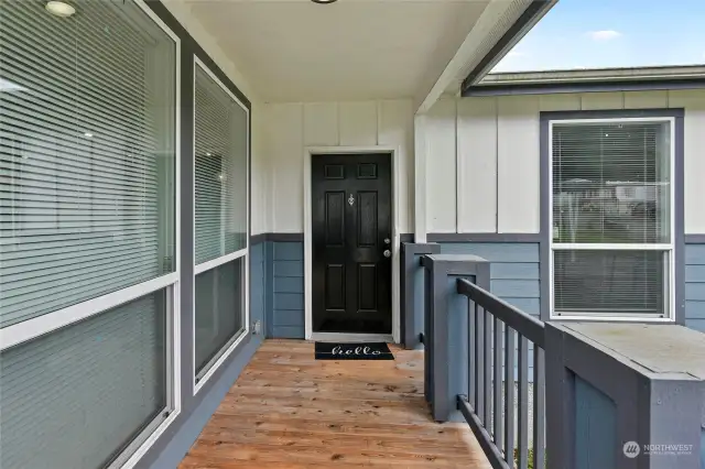 Step into this charming home through the spacious covered entryway that provides shelter from the elements and adds architectural interest too.