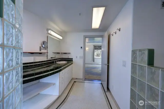 Primary bath, walk in wet room contains the double head shower. glass block wall allows plenty of light.