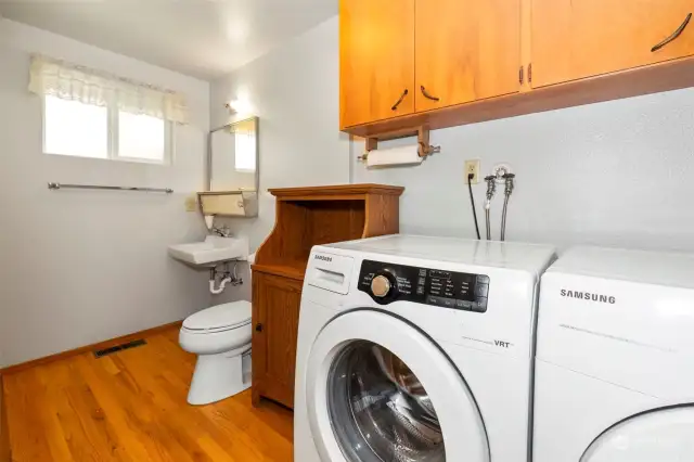 Utility room with a half bath, both the washer and dryer stay.