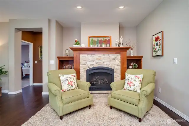 Cozy sitting area by the fireplace with built-in shelving. High output gas fireplace can heat most of the home!