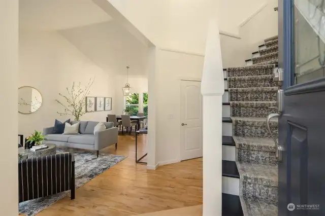 Stairs lead to the upper three bedrooms including the spacious primary suite.