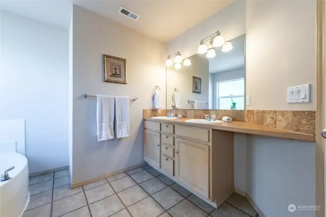 The primary bath has 2 sinks, a soaking tub and a shower.  Plus plenty of room to move around.