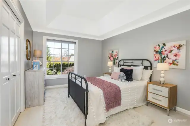 Spacious, upper level bedroom with a private ensuite and custom closet system.