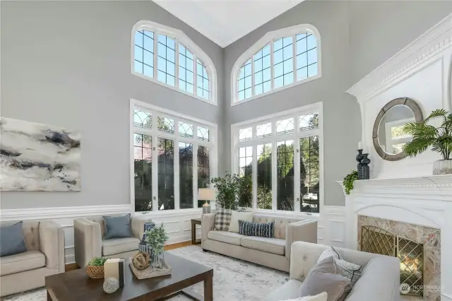 Revel in abundant natural light streaming through lead glass windows, the majestic allure of soaring ceilings, and the inviting warmth of French doors throughout this home beckon you to the lush grounds.