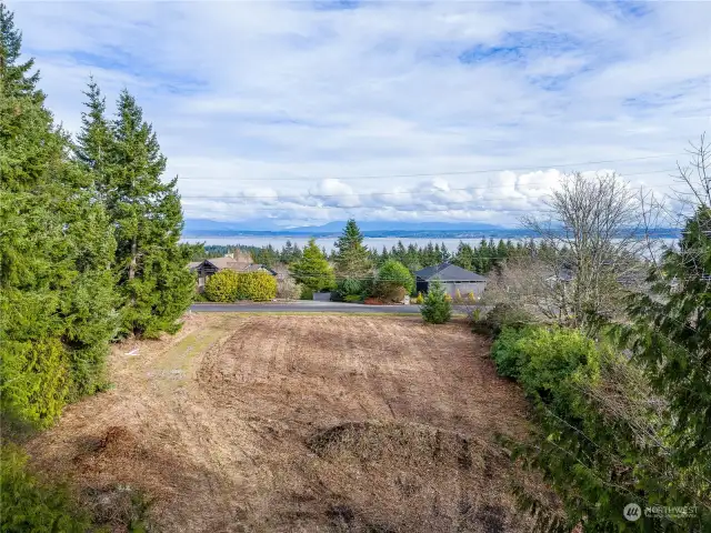 Flat 2.5 acre lot. Low drone shot in this picture to show potential for Sound views, depending on build.