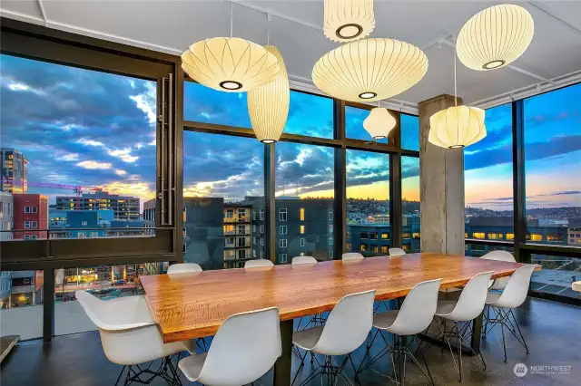 Large, gracious dining area with views through concrete, custom steel, and floor-to-ceiling glass. West-facing windows have IR-reflecting film and tint.