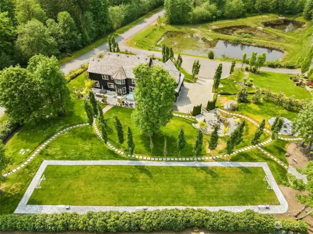This aerial shows off the beautifully designed 2+ acre property and house sited on a private lot across from the pond. Geese, a family of ducks, otters, deer and dozens of species of birds are fun to watch.
