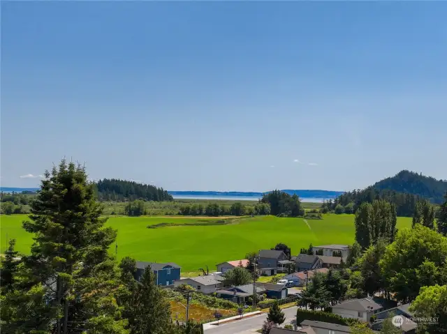 Step out onto the expansive deck, outstretched to the edge of the wall of granite below. Breathe deeply of the refreshing breezes and take in this masterpiece of picturesque farmland and Salish Seas beyond. You deserve it!