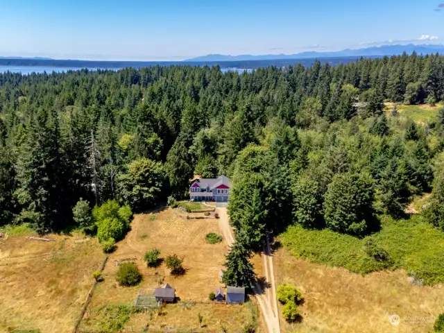 The home sits well off the country road on the private 3.15 acres with sunny pastures to the front and a beautiful back yard that goes well into the woods.