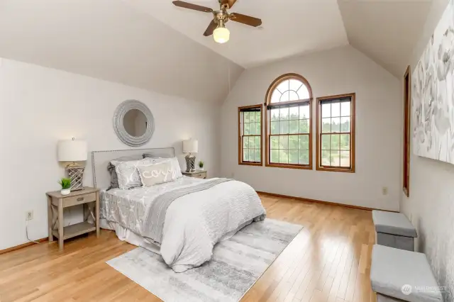 The high vaulted ceilings are accented by beautiful wood wrapped windows.