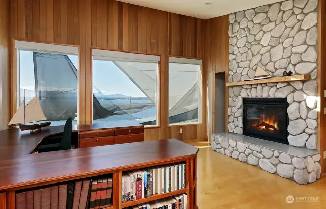 Library/Office off the primary: unobstructed view if sun sails are not up. Propane fireplace with river rock surround, Birch hardwood floors, cedar walls. Don't forget to look in the closet in this room.