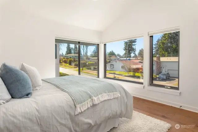 Third top floor bedroom perched high above the street and flooded with natural light from large picture windows  Sunny yard for main home upstairs fully fenced with Alaskan Yellow Cedar