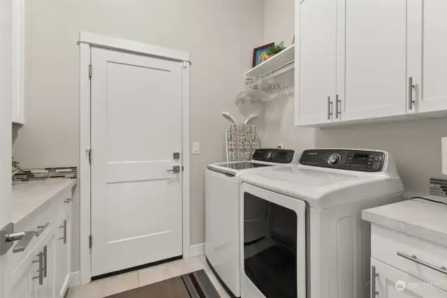 Ample cabinets in laundry room.