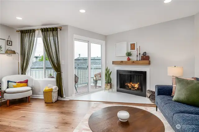 Cozy, refreshed fireplace surround and new handcrafted mantle are a warm and inviting centerpiece. The new large sliding doors lead you out to the relaxing and charming view deck - ready for morning coffee or afternoon happy hour.