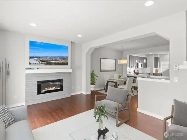 Home is virtually staged - Light filled living room with electric fireplace and hardwood flooring.