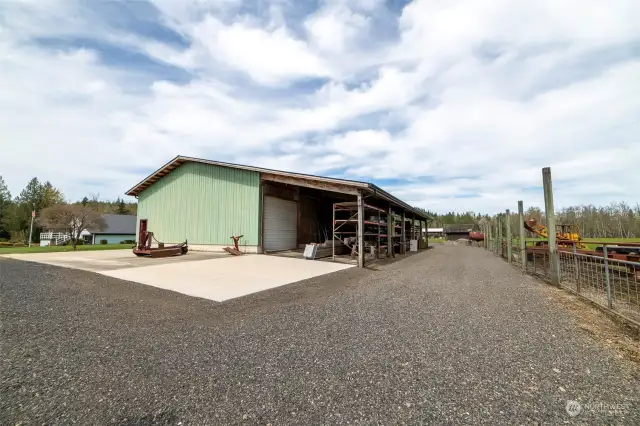 Shop, lean to, parking with a drive around clearance and fencing out to field and to Cowlitz River...