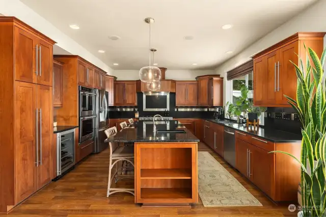 An amazing Chef's kitchen with double beverage drawers, wine fridge, double ovens and ample counter and cupboard space