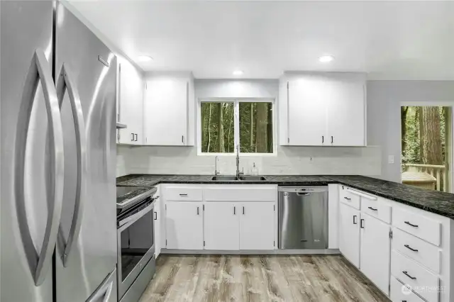 The upgraded kitchen features new countertops, stainless appliances, flooring and sink.