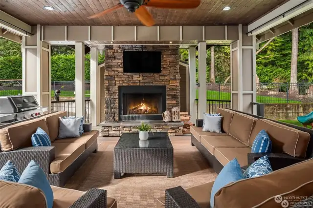 Covered outdoor living space with fireplace for year round use.