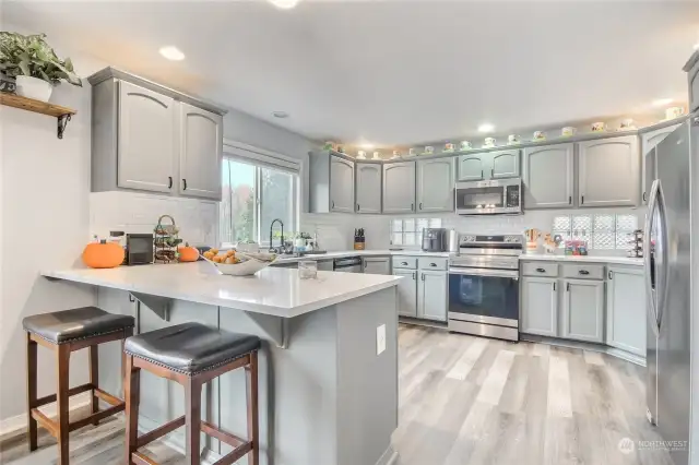 The kitchen is a chef's delight boasting new granite countertops in Jan '22, stainless appliances, and a peninsula island with eating bar.