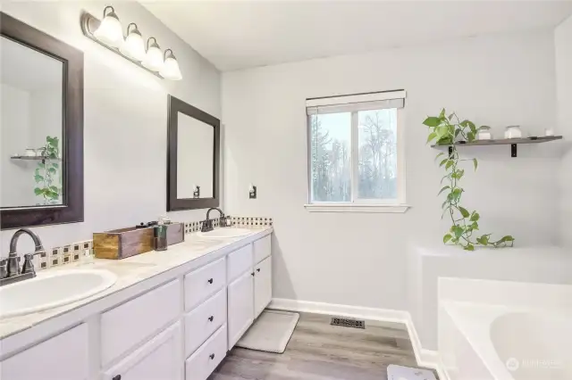 5 pc primary bath with dual sink vanity and a soaking tub.