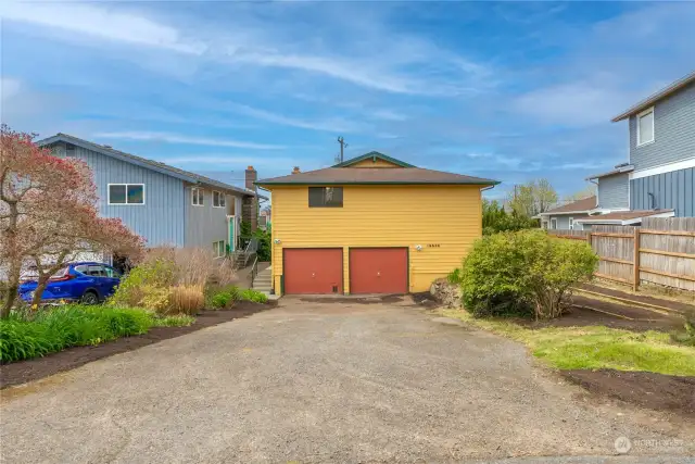 Off the Alley- Access to the 2 car garage + storage room! Very large driveway creates ample off-street parking
