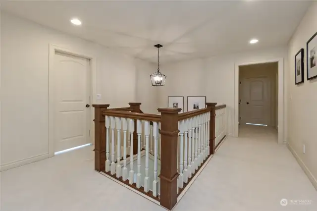 This spacious upstairs landing serves as the gateway to four inviting bedrooms and a guest bath in this exceptional home. Step into a realm where every detail has been meticulously crafted to create a harmonious living experience
