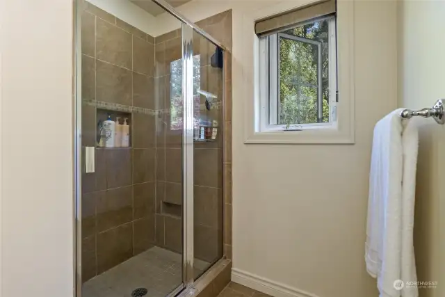 The separate enclosed shower in the primary bath features a stylish tile surround that adds a touch of elegance to the space. Enjoy the comfort and convivence of the shower area within the primary bath, perfect for unwinding after a long day or starting your day refreshed!