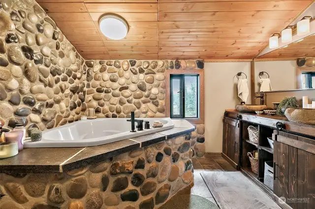Custom built stone soaking tub and rain shower