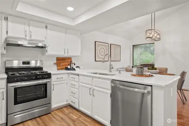KITCHEN LOVE | This tucked away kitchen is perfectly place to provide access to all parts of the upper level. Cabinets have been freshly painted, and new countertops and new stainless steel appliances (except the fridge) make this kitchen the heart of the home.