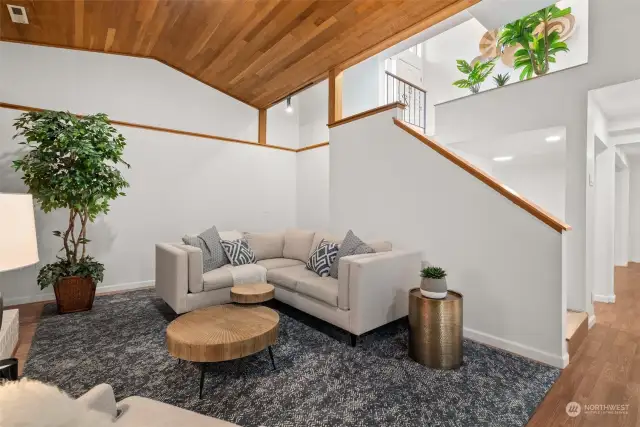 LOWER LEVEL LIVING | Check out this rec room! There is so much space to spread out, host get-togethers, and entertain. Down the hallway in the right side of the photo are more rooms for multiple uses.