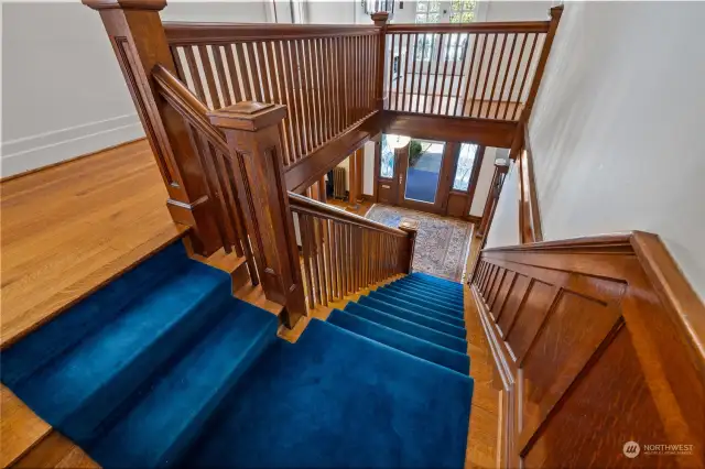The gorgeous staircase flows up to the large second-floor landing.